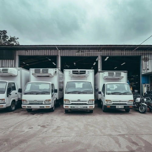 multiple refrigerated trucks parked for maintenance & repair services, highlighting the business's capacity to handle a large feet